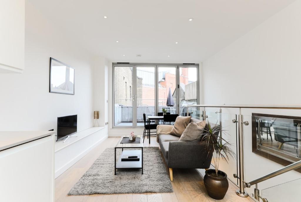 a living room with a couch and a table at StayInn Trafalgar Square in London