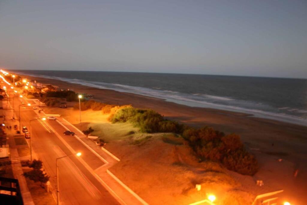 a view of a street at night with the ocean at Excelente departamento vista al mar + 2 cocheras in San Bernardo
