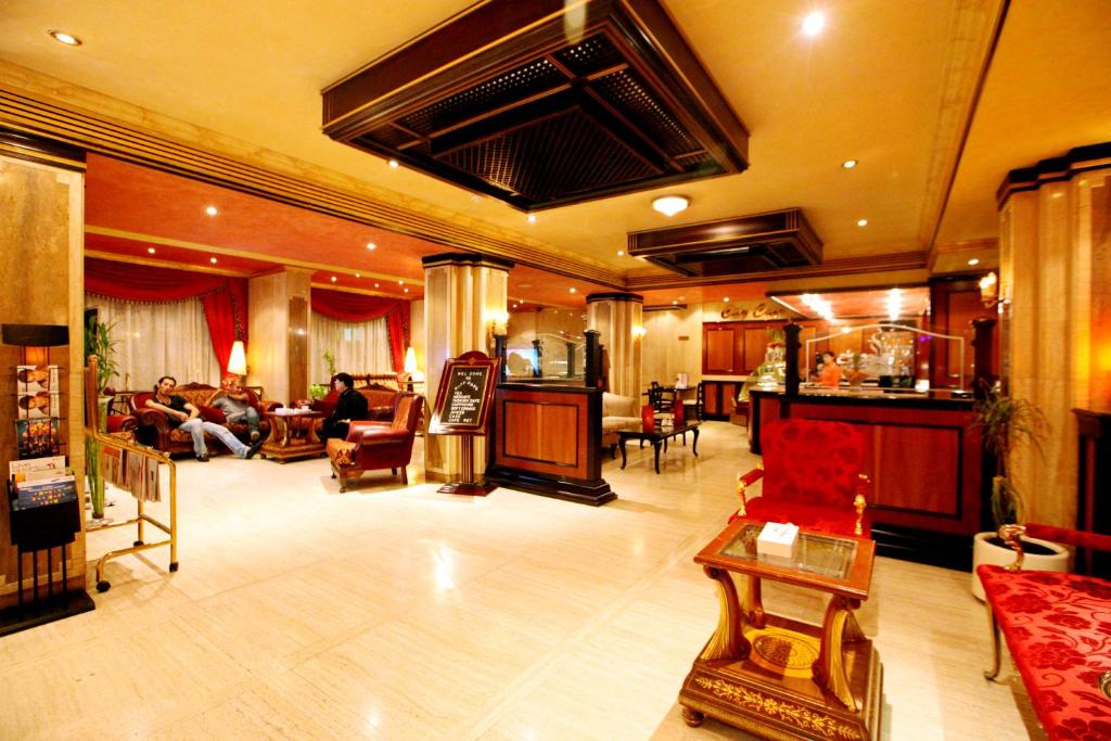 a large living room with people sitting in chairs at Gulf Inn Hotel Deira Formerly City Star Hotel in Dubai