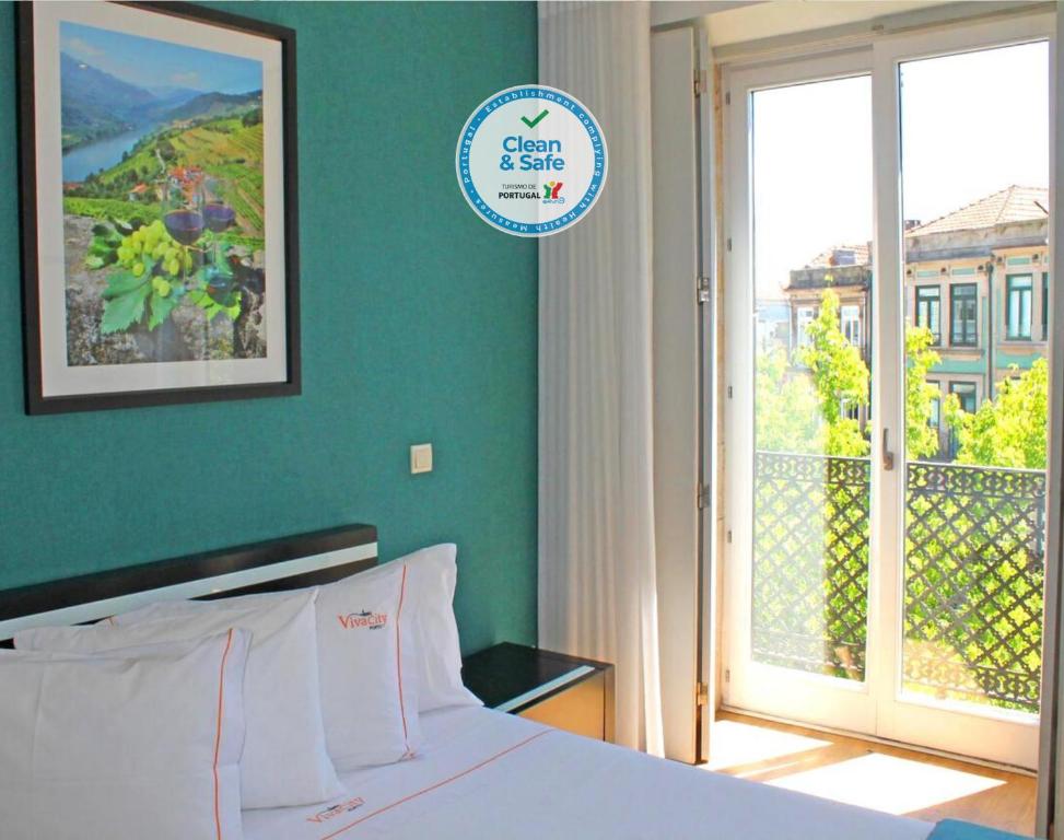 a bedroom with a blue wall and blue curtains at Vivacity Porto - Rooms & Apartments in Porto