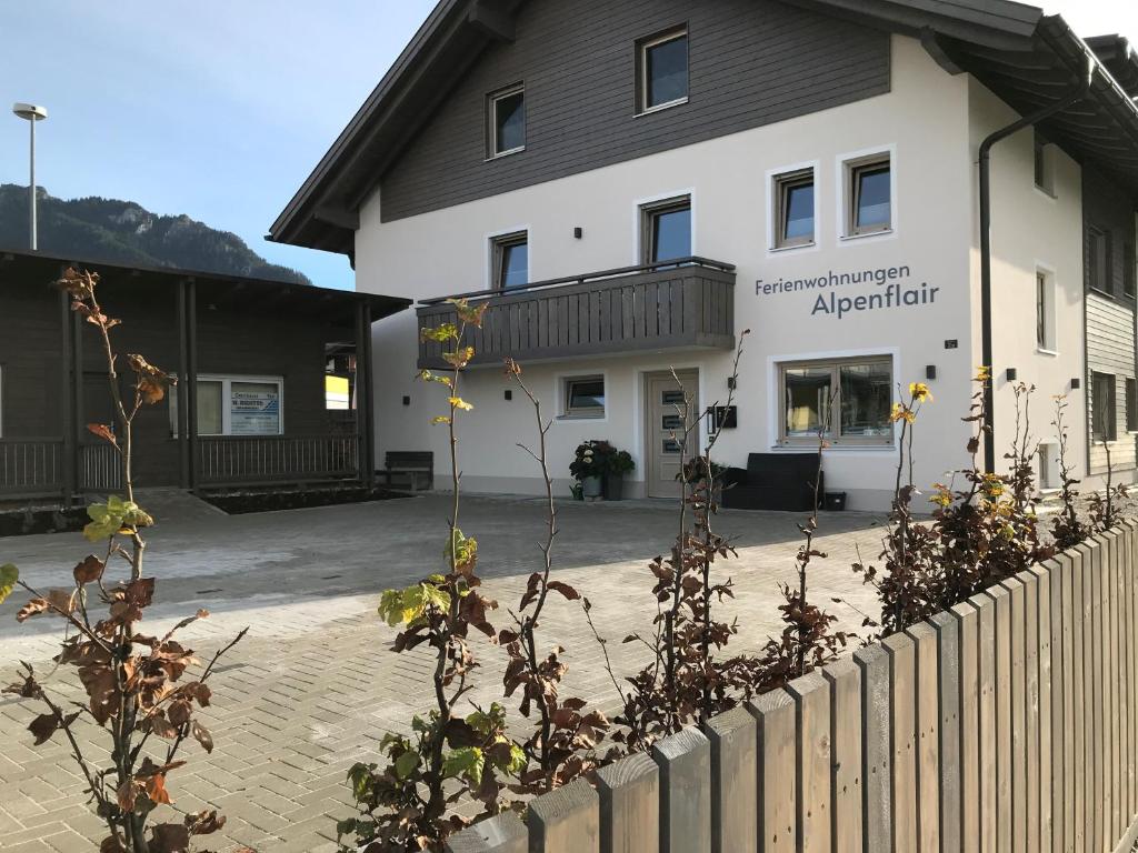 a building with a fence in front of it at Ferienwohnungen Alpenflair - barrierefrei urlauben in Oberammergau