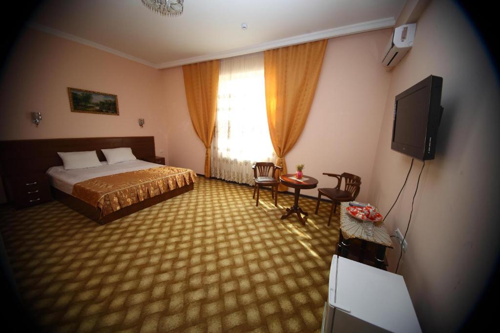 En eller flere senger på et rom på Samarkand Dream Hotel
