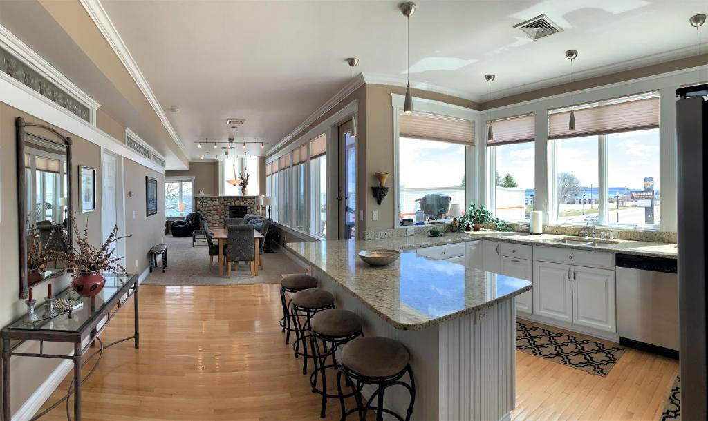 a large kitchen with a large island with bar stools at Pier Harbor #2 in Saint Ignace