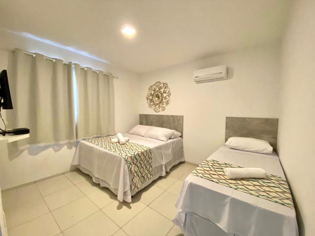Postel nebo postele na pokoji v ubytování Flats Morro de São Paulo