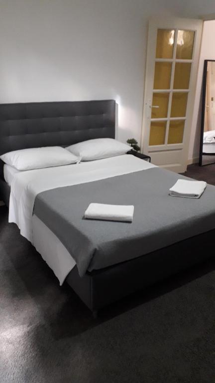a bedroom with a large bed with two towels on it at Chambres d'Hotes Centre Ville in Agen