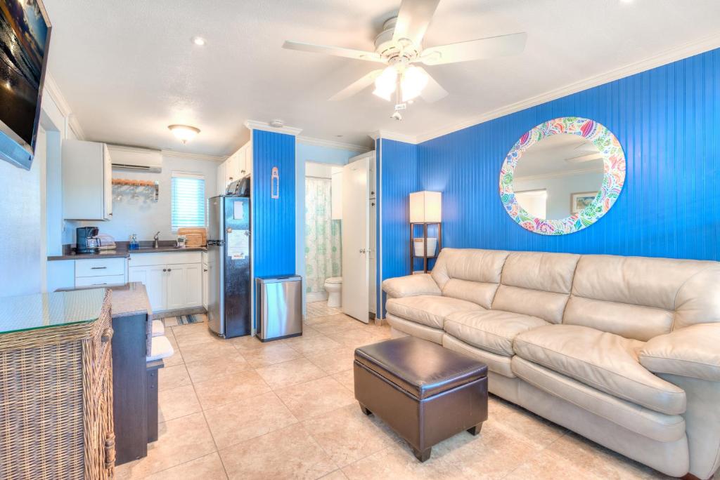 a living room with a couch and a kitchen at Tropic Terrace #51 - Beachfront Rental condo in St. Pete Beach