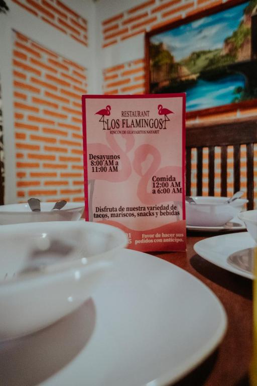 Un certificado, premio, letrero u otro documento en Bungalows Flamingos