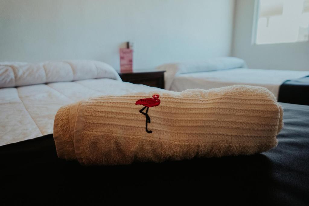 Una cama o camas en una habitación de Bungalows Flamingos
