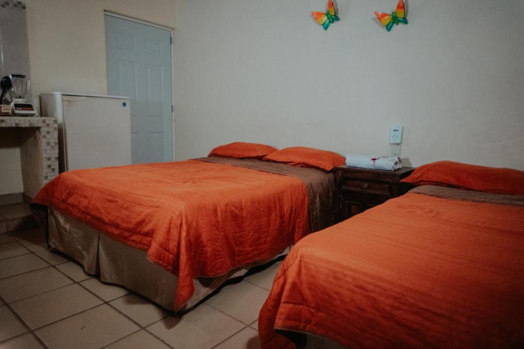 Una cama o camas en una habitación de Bungalows Flamingos
