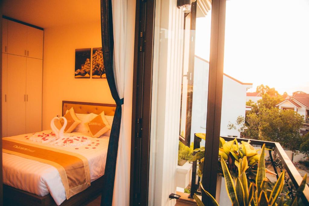 Postel nebo postele na pokoji v ubytování Dawn Villa Homestay Hội An