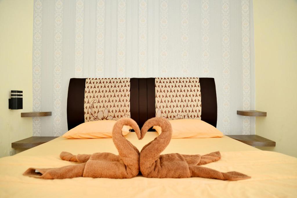 Haura syariah home stay tesisinde bir odada yatak veya yataklar