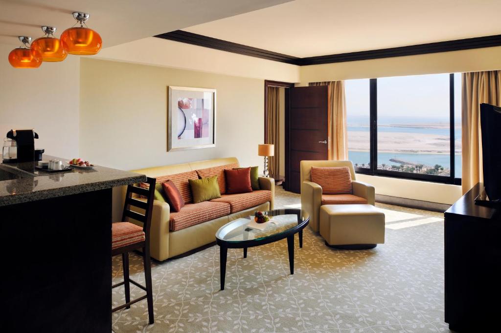 a living room with a couch and a table at InterContinental Abu Dhabi by IHG in Abu Dhabi
