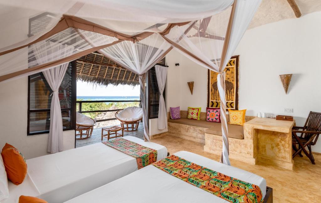 Postel nebo postele na pokoji v ubytování Sunshine Bay Hotel Zanzibar