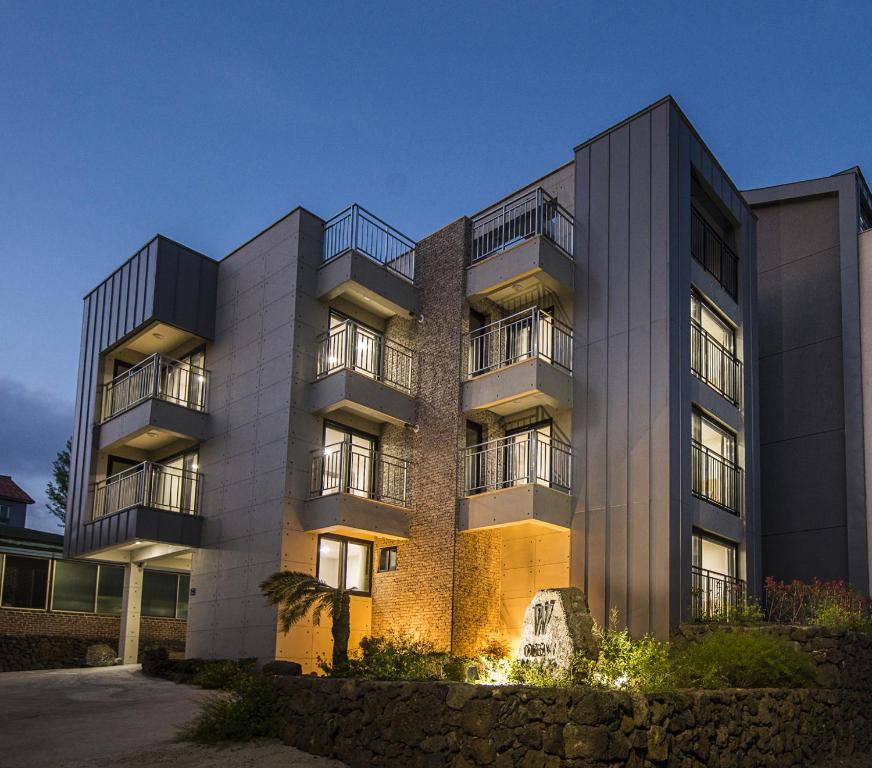 a large building with lights in front of it at W Ocean Pension in Seogwipo