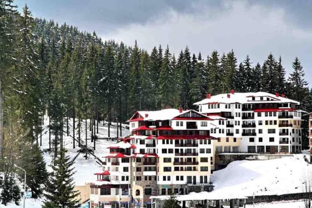 a large building on a snow covered mountain at Апартамент Пампорово Палас - Pamporovo Palace in Pamporovo