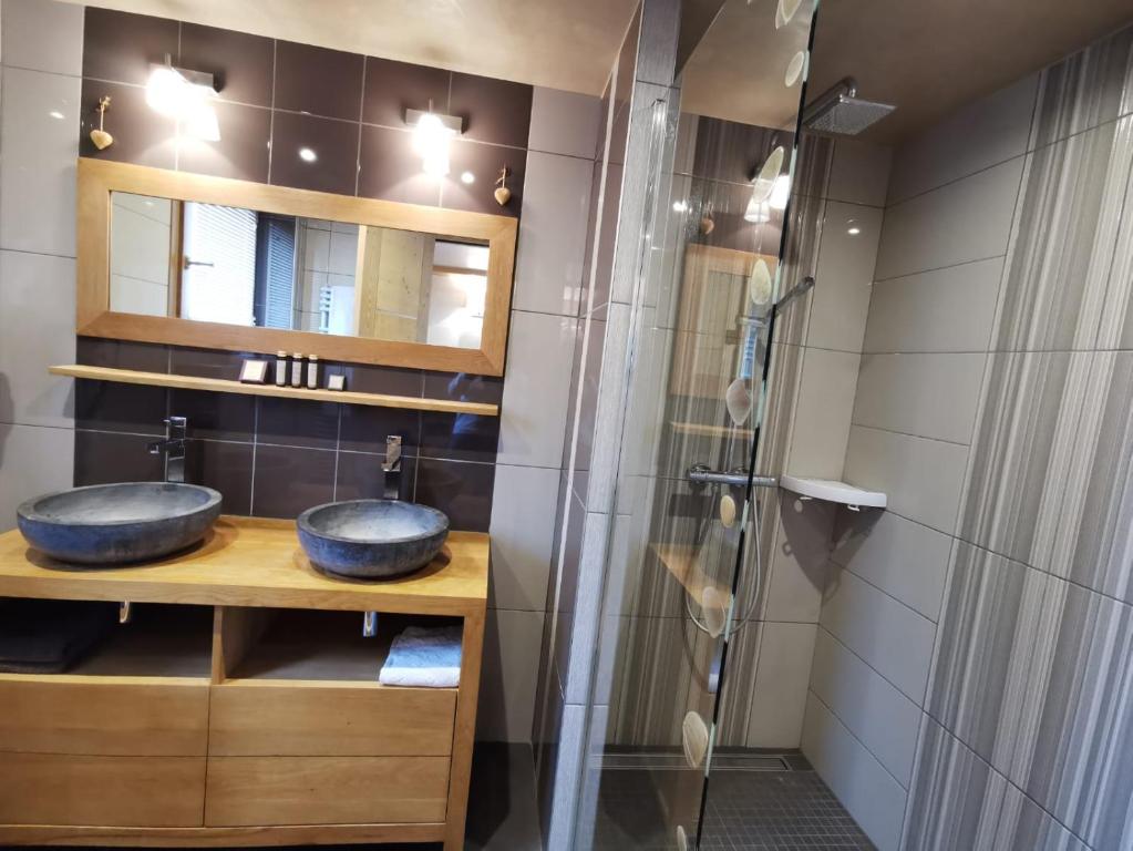 a bathroom with two sinks and a shower at Chalet Emilie in Courchevel