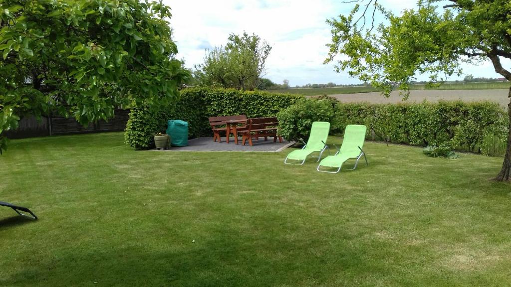 a yard with chairs and a table and a table and a table and chairs at Ferienwohnungen Denker in Seefeld