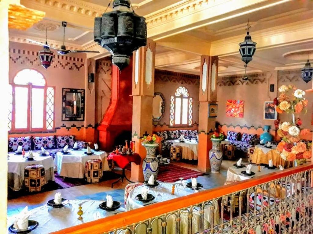 une salle à manger avec deux tables dans un bâtiment dans l'établissement Dromadaire Gourmand, à Zagora