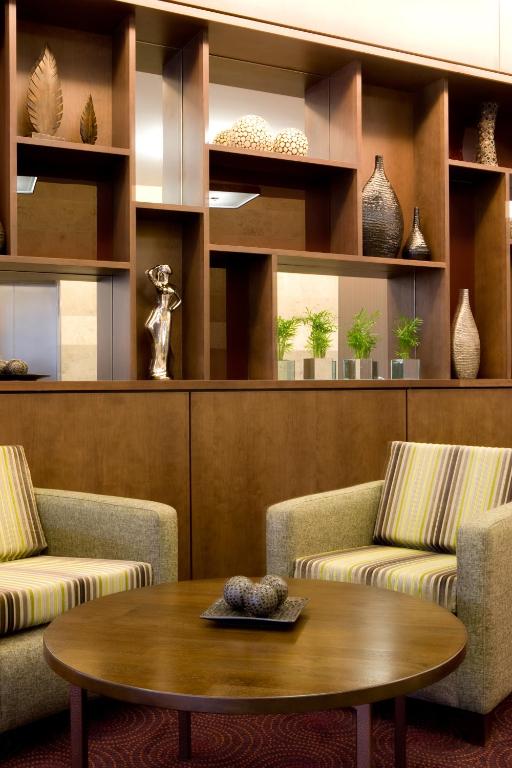 a living room with two chairs and a table at Leonardo Hotel Aberdeen in Aberdeen