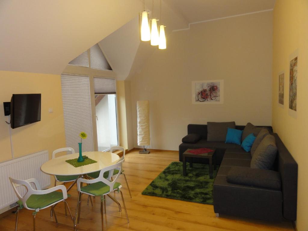 a living room with a couch and a table at Apartament Bukowa in Wisła