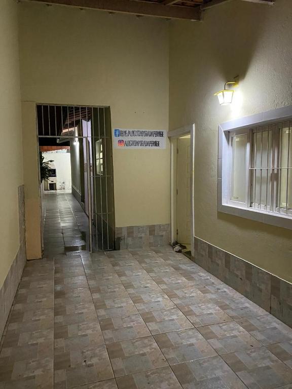 an empty room with a wall and a tile floor at Peruibe centro mar 944 in Peruíbe