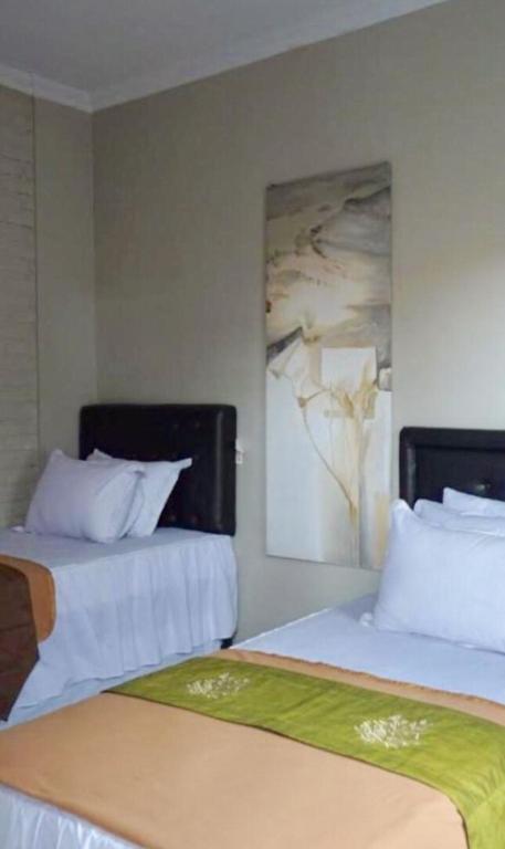 Postel nebo postele na pokoji v ubytování Argya Guesthouse