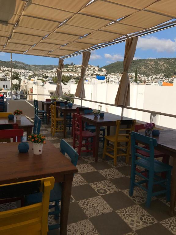 a restaurant with tables and chairs with a view at Halikarnas Pansiyon in Bodrum City