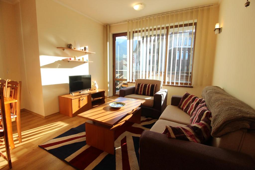 a living room with a couch and a table at 2 bedroom apartment near Gondola in Bansko