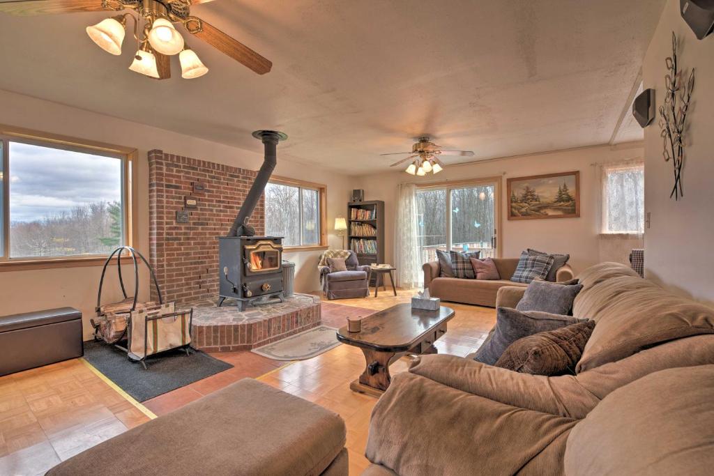 a living room with a couch and a fireplace at Private Hot Tub and Fireplace Poconos Home! in Pleasant Mount