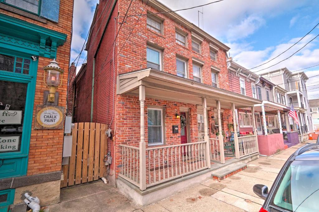 a brick building with a porch on a street at Cozy Lambertville Abode in the Heart of Downtown! in Lambertville