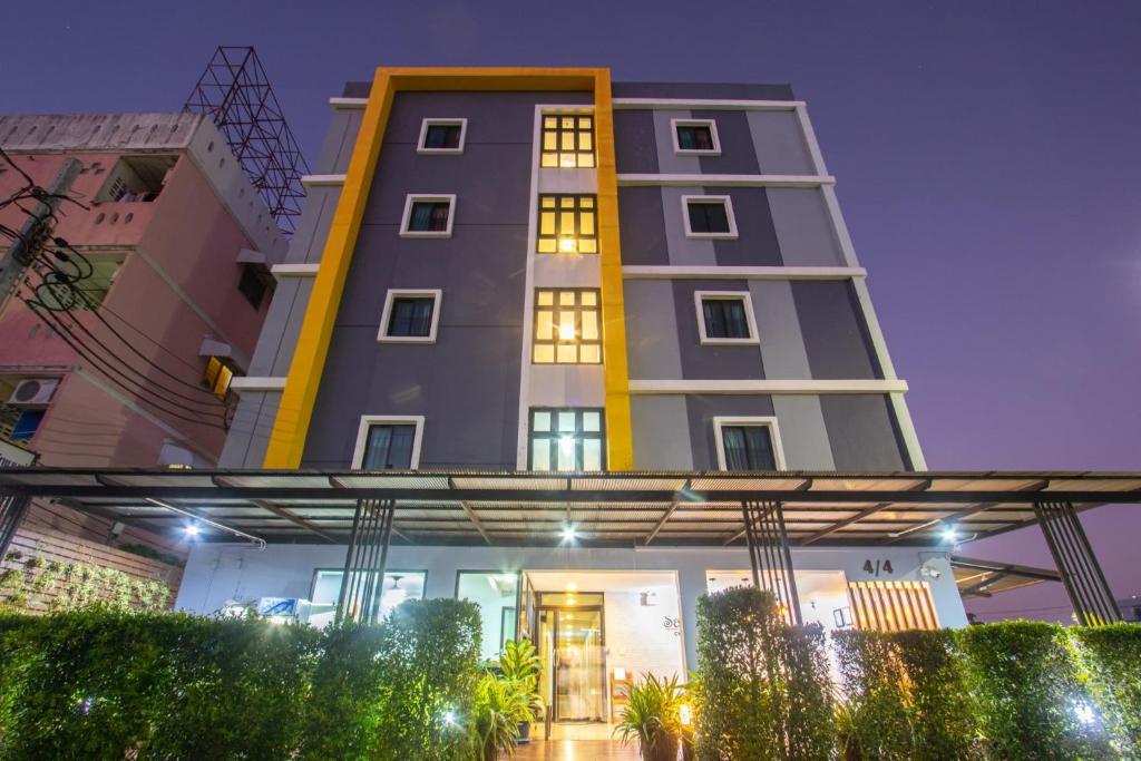 a tall building with lights in front of it at Salinsiri at Lat Krabang in Lat Krabang