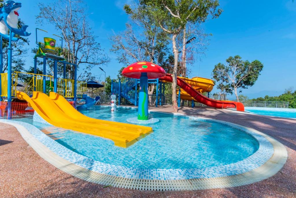 a pool with a water park with a slide at MyRus Resort Langkawi in Pantai Cenang