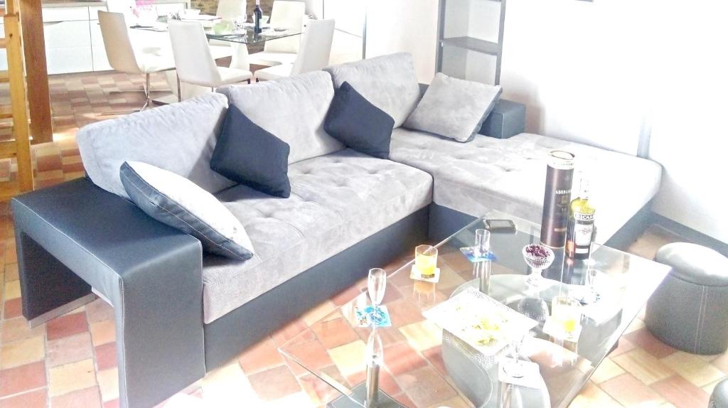 a living room with a couch and a glass table at Maison de 2 chambres a Saint Gilles Croix de Vie a 300 m de la plage avec terrasse amenagee et wifi in Saint-Gilles-Croix-de-Vie