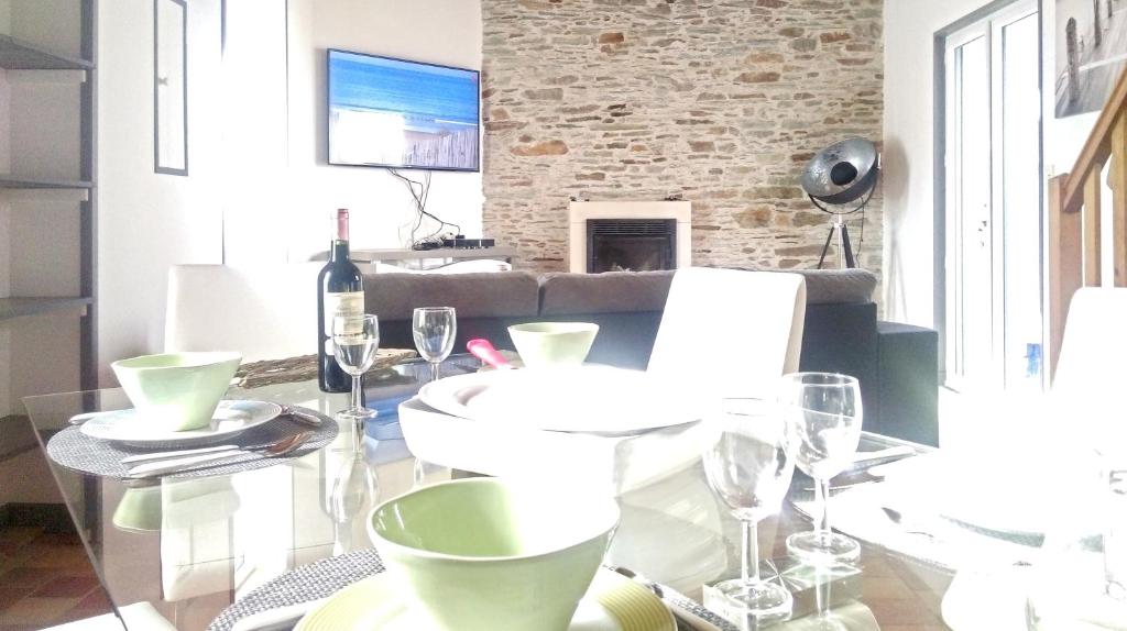 a dining room with a glass table with wine glasses at Maison de 2 chambres a Saint Gilles Croix de Vie a 300 m de la plage avec terrasse amenagee et wifi in Saint-Gilles-Croix-de-Vie