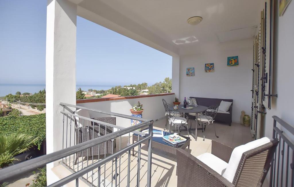 a balcony of a house with a table and chairs at 2 bedrooms apartement at Sciacca 400 m away from the beach with sea view furnished garden and wifi in Sciacca