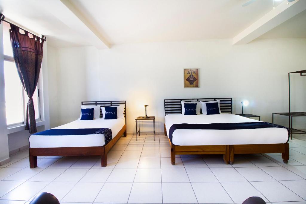 Postel nebo postele na pokoji v ubytování Hotel Plaza Galindo