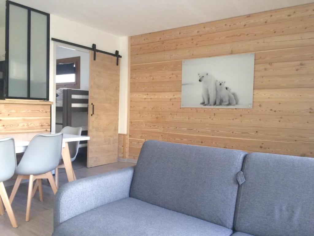 a living room with a blue couch and a table at Appartement d&#39;une chambre avec balcon amenage et wifi a Briancon in Briançon