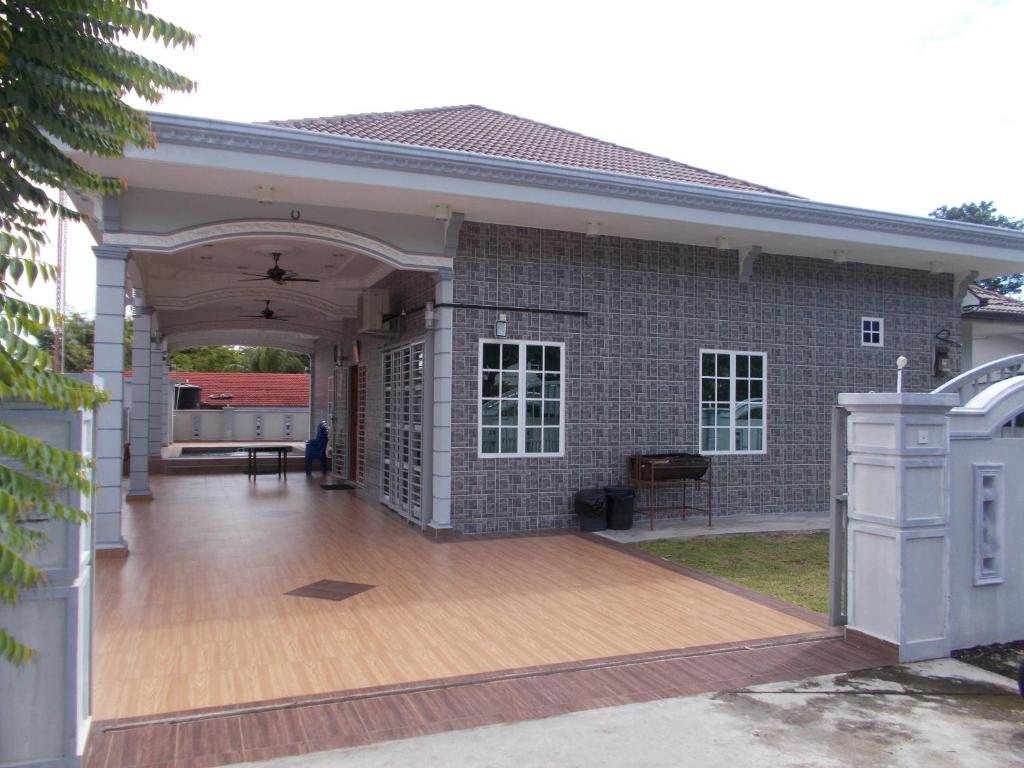a large brick building with a wooden deck at Dorry Villa 2226 in Port Dickson
