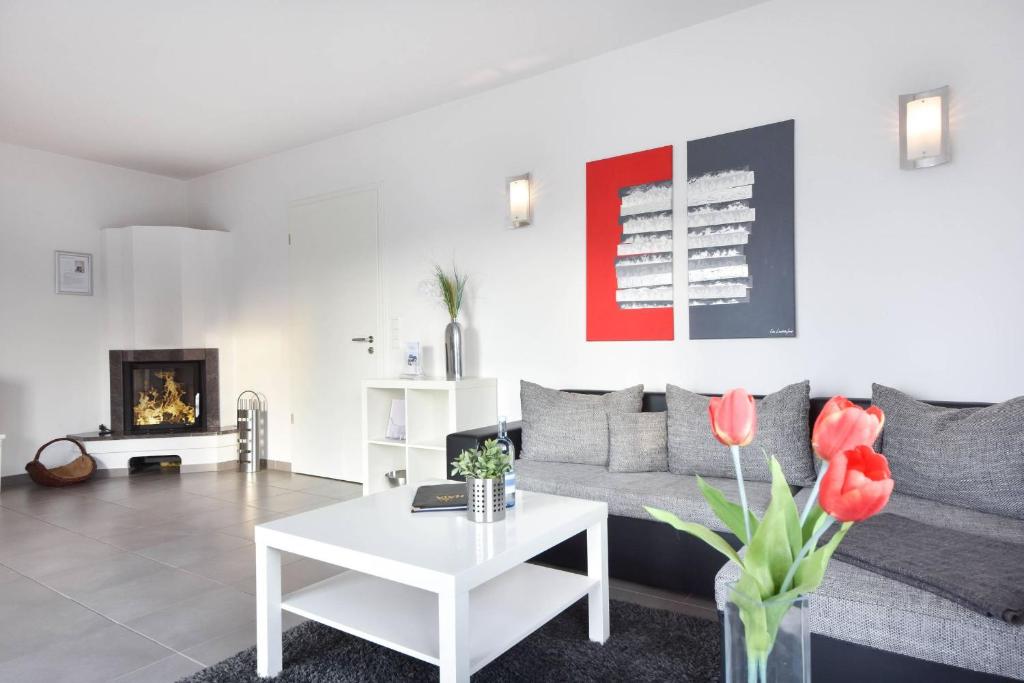 a living room with a couch and a table at Villa Kaja Wohnung Ostseestrand in Korswandt