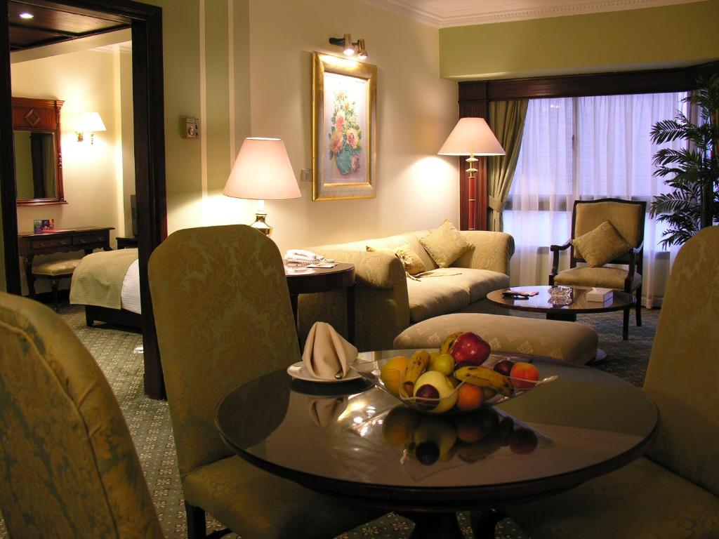 a hotel room with a table with fruit on it at Pyramisa Downtown Residence in Cairo