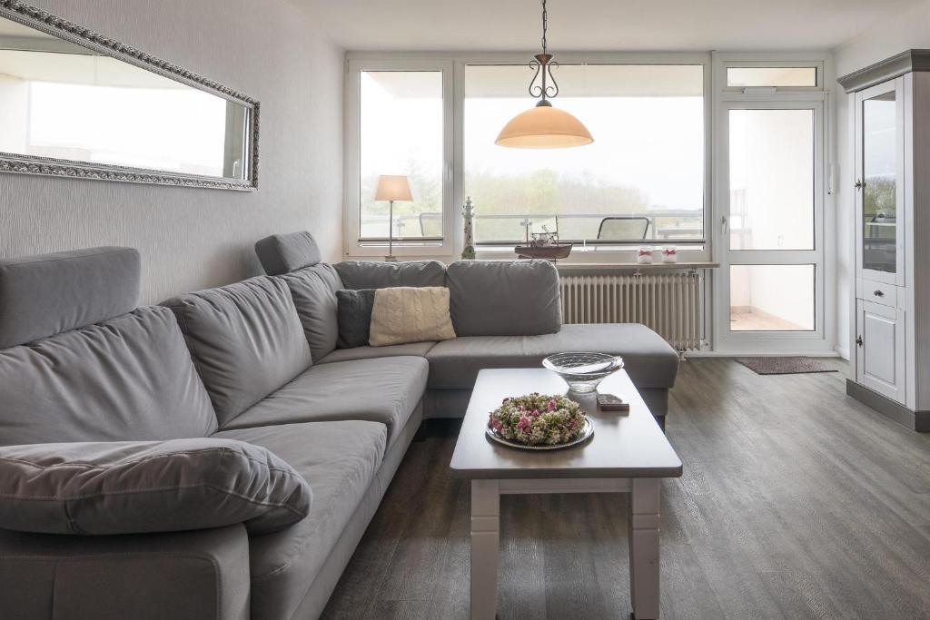a living room with a couch and a table at Strandperle in Wyk auf Föhr
