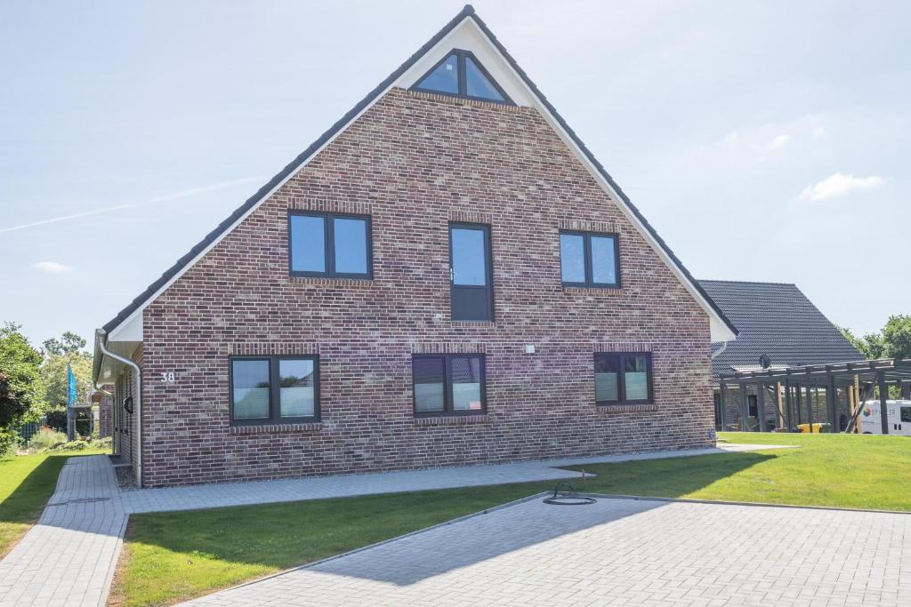 a large brick house with a triangular roof at Nordlicht in Breklum