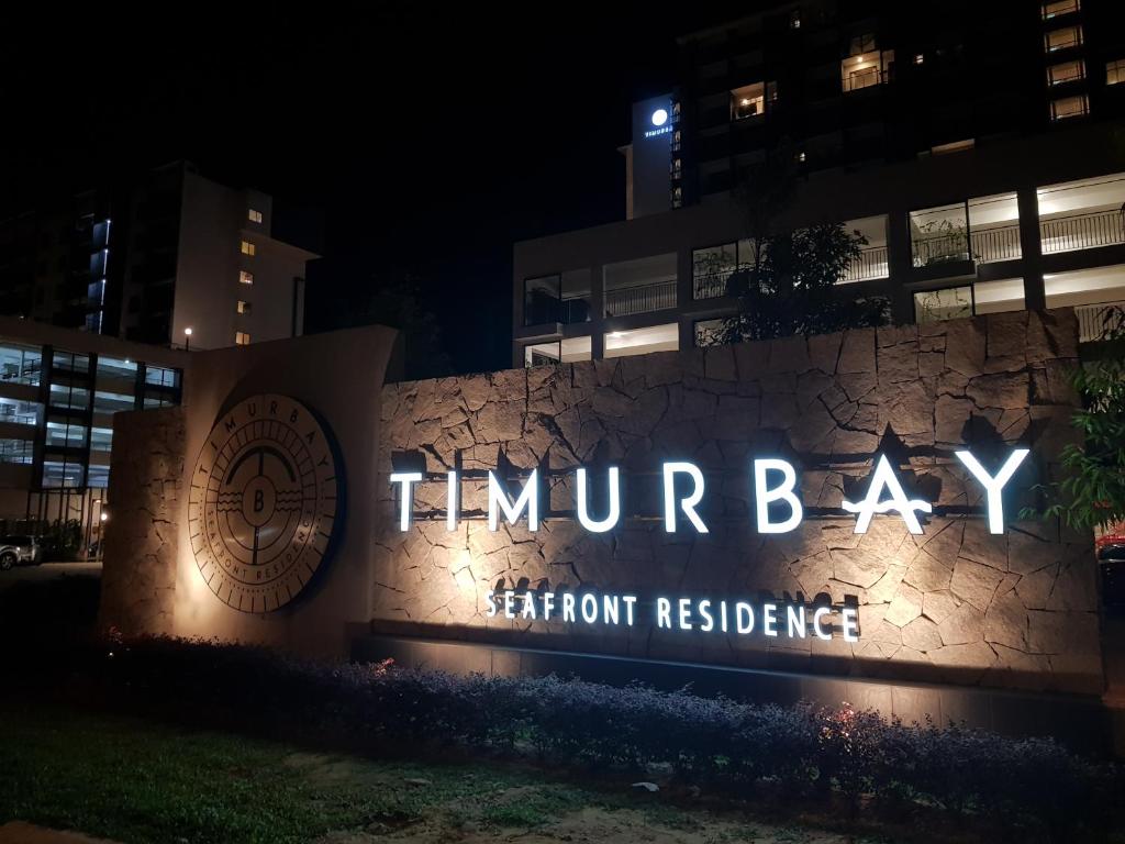 a sign that reads tummy bay at night at Timurbay studio apartment facing beautiful beach in Kuantan