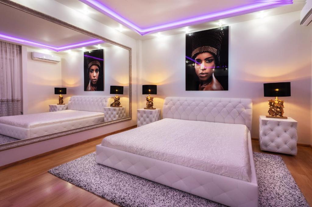 sypialnia z 2 łóżkami i dużym lustrem w obiekcie Premium Jacuzzi Apartment w Kłajpedzie