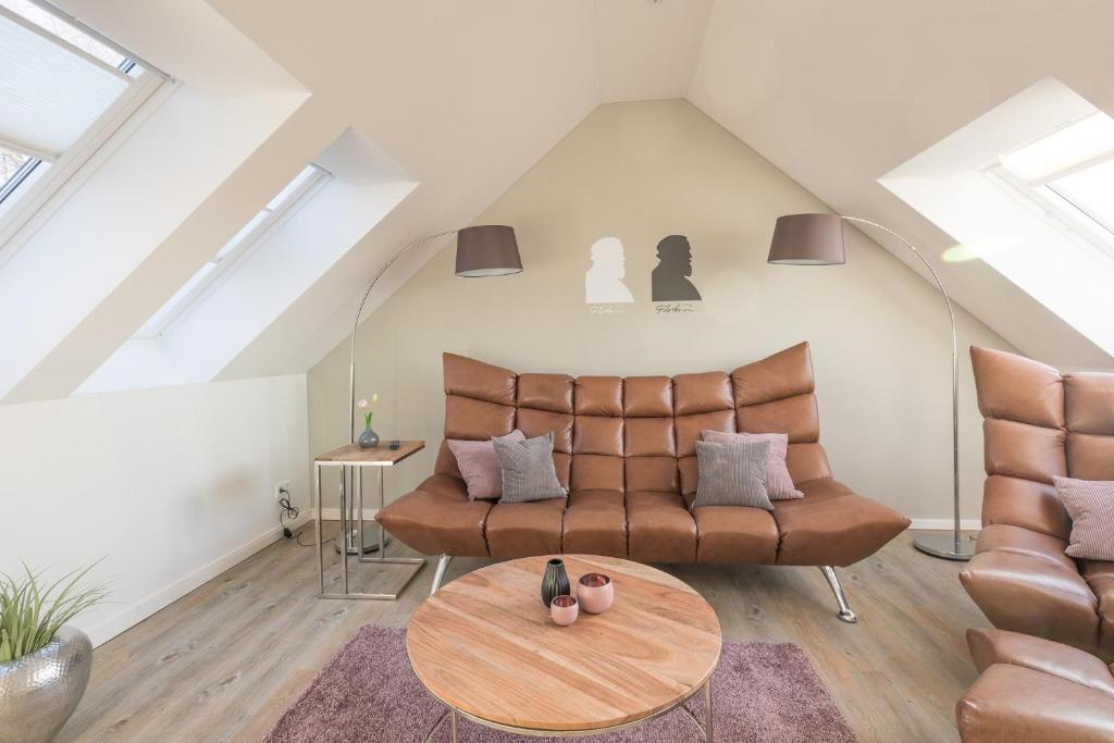 a living room with a couch and a table at Penthouse Theo in Husum