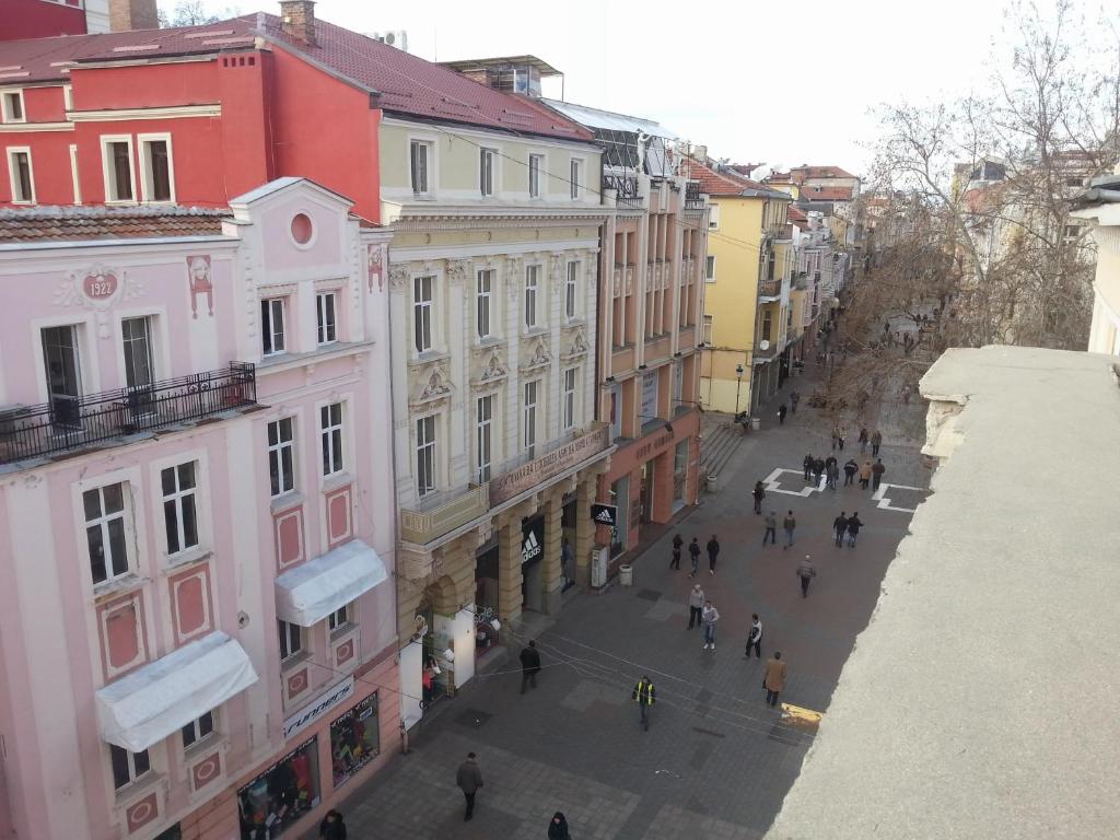 a group of people walking down a street with buildings at Hostel Center Plovdiv in Plovdiv