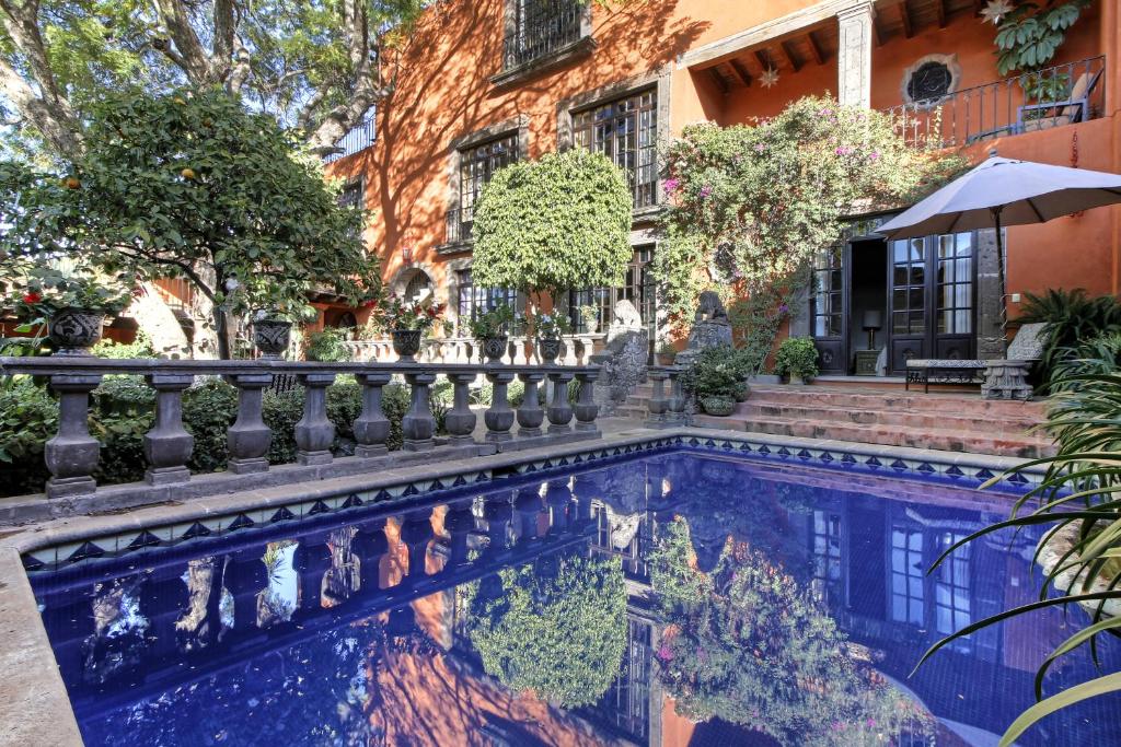 a swimming pool in front of a house at Casa Schuck Boutique Hotel in San Miguel de Allende