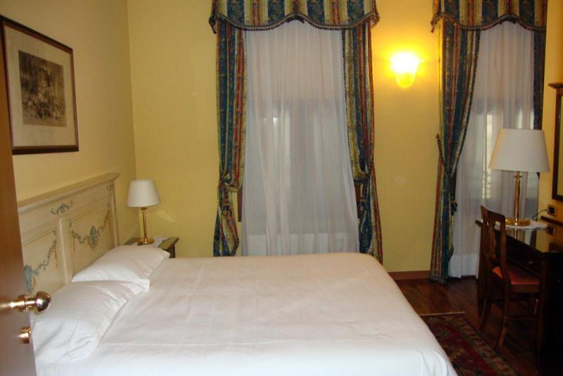 Postel nebo postele na pokoji v ubytování Hotel La Loggia