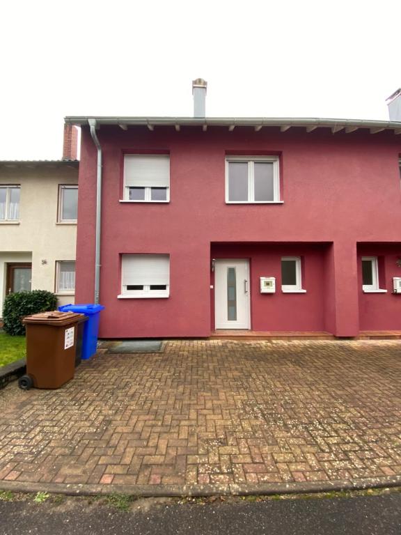 a red house with a brick driveway at Tokis Feriendomizil 2.0 in Bad Säckingen