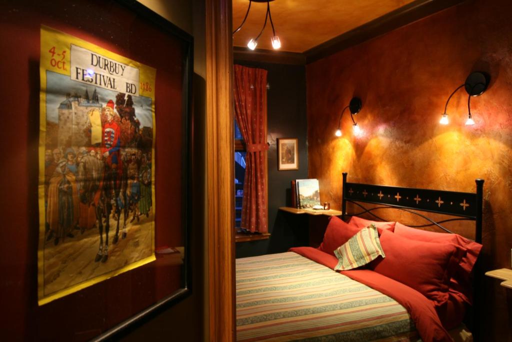 a bedroom with a bed with a poster on the wall at A La Carte Bed & Breakfast in Montreal